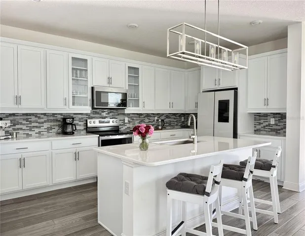 a kitchen with cabinets appliances and a counter space