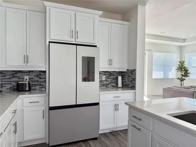 a bathroom with a double vanity sink a mirror and a bathtub