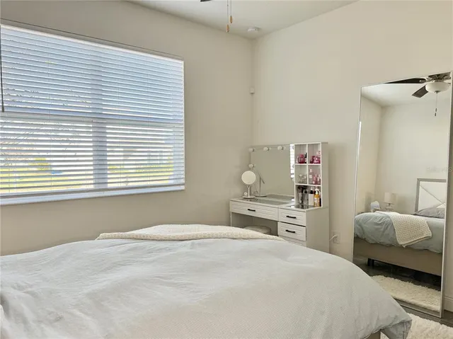 a bedroom with a bed and lamp