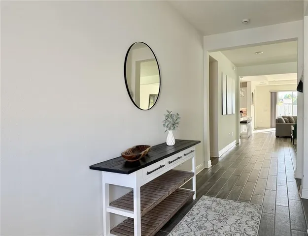 a view of a a dining room with furniture window and wooden floor