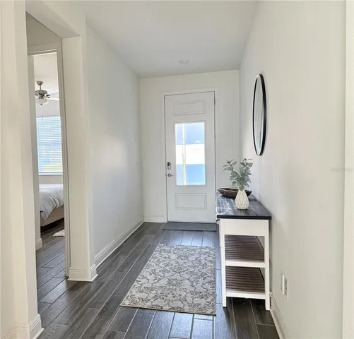 a view of a a dining room with furniture window and wooden floor