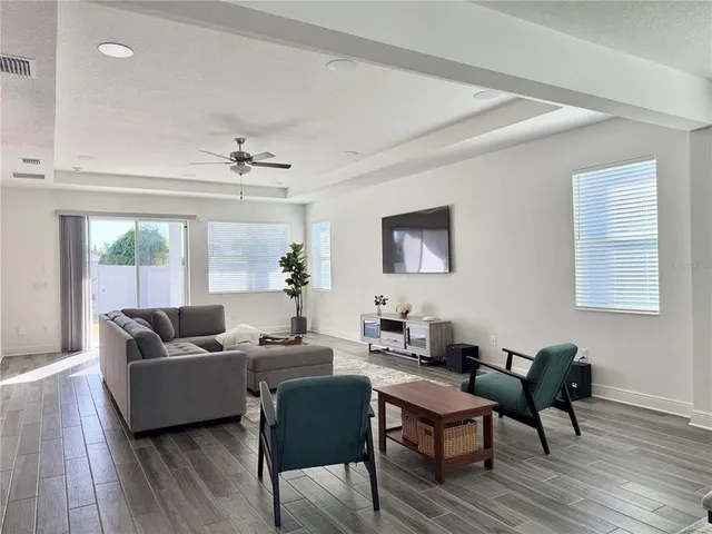 a living room with furniture kitchen view and a table