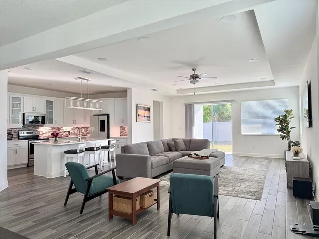 a kitchen with stainless steel appliances a stove refrigerator sink and white cabinets