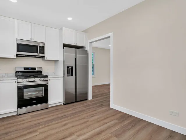 a kitchen with stainless steel appliances a refrigerator microwave and sink