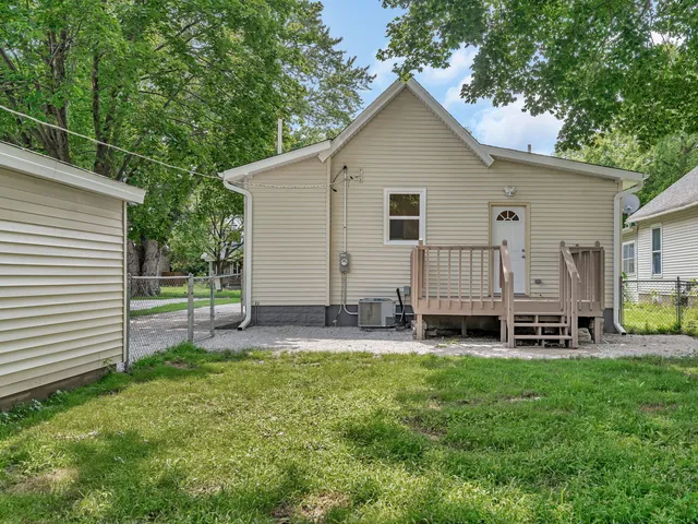 a view of a house with a yard and sitting area