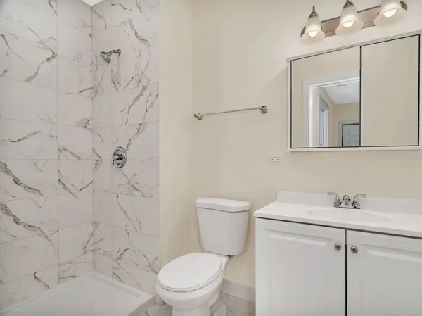a white toilet sitting next to a bathroom sink