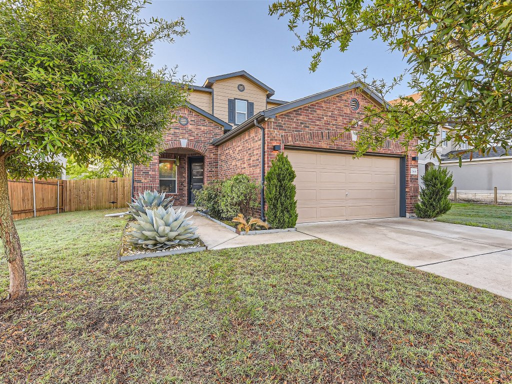 7601 Rio Pass Austin, TX 78724 - Photo 1 of 11 a front view of a house with a yard and garage