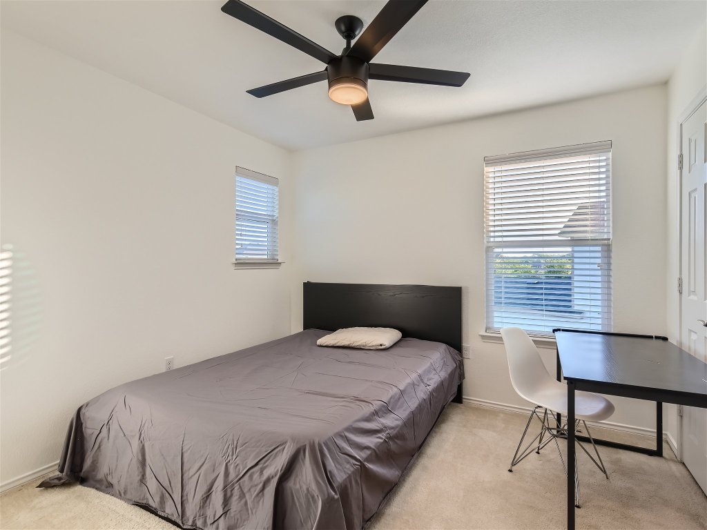 7601 Rio Pass Austin, TX 78724 - Photo 8 of 11 a bedroom with a bed and a window