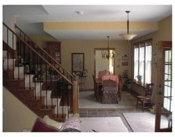 333 Service Road, Unit 2 Sandwich, MA 02537 - Photo 4 of 8 a dining room with lots of furniture and a chandelier