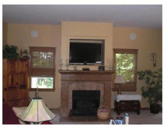 333 Service Road, Unit 2 Sandwich, MA 02537 - Photo 6 of 8 a living room with furniture a flat screen tv and a fireplace