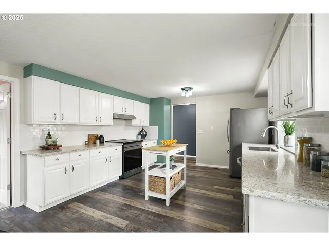 a kitchen with a dining table chairs and white appliances