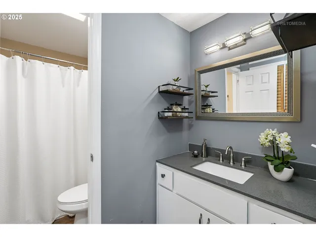 a bathroom with a shower curtain and a sink