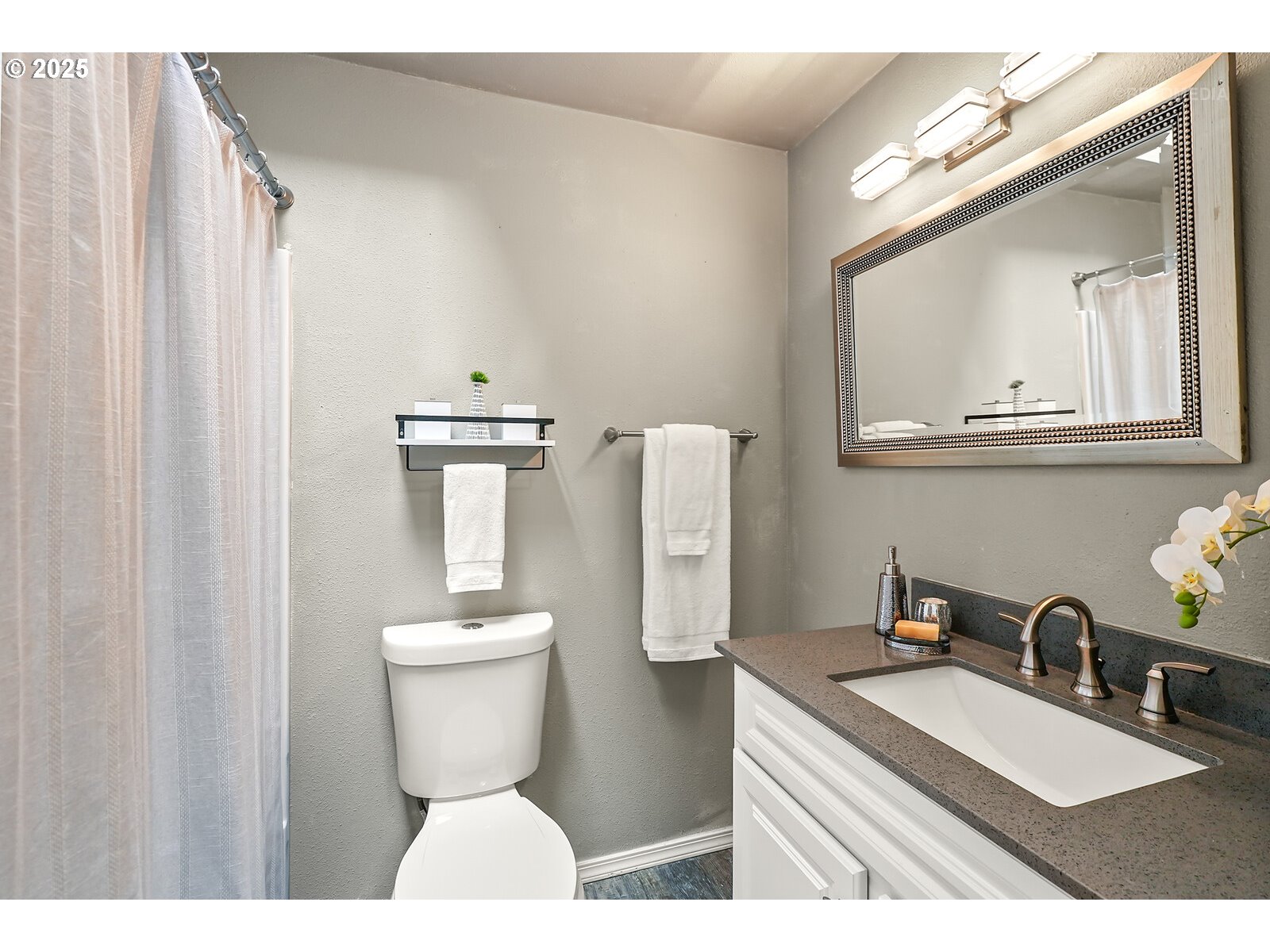 20490 Southwest Frances Street Beaverton, OR 97003 - Photo 24 of 32 a bathroom with a toilet a sink and mirror