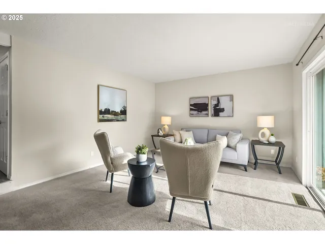 a living room with furniture a window and a table