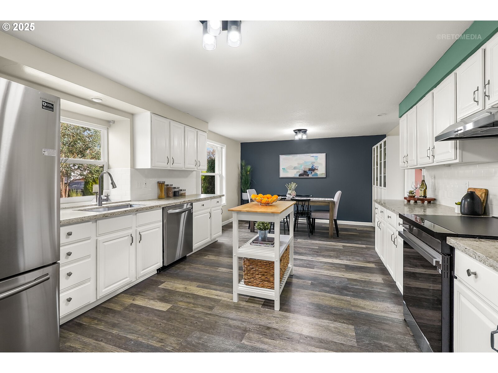 20490 Southwest Frances Street Beaverton, OR 97003 - Photo 7 of 32 a kitchen with a table chairs stove and cabinets