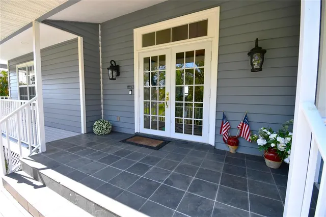 a view of front door of house with large windows