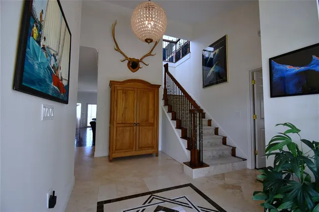 a view of a workspace with furniture and a fan