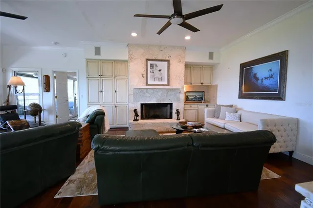 a living room with fireplace furniture and a wooden floor