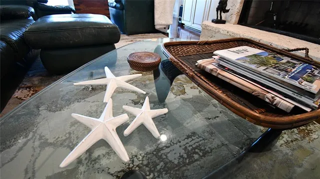 a bedroom with a bed a mirror on dresser and a wooden floor