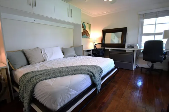 a bedroom with a bed and a lamp