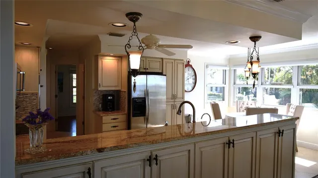 a kitchen with stainless steel appliances a refrigerator sink microwave and stove