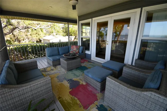 a view of a balcony with table and chairs and wooden floor