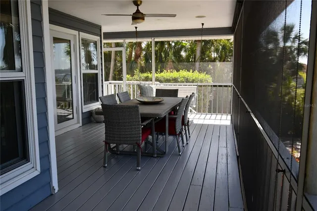 a view of a balcony with table and chairs and wooden floor