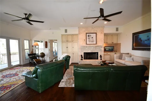 a living room with furniture a fireplace and a flat screen tv