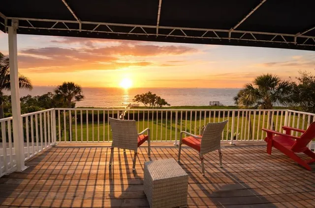 a view of a balcony with chairs