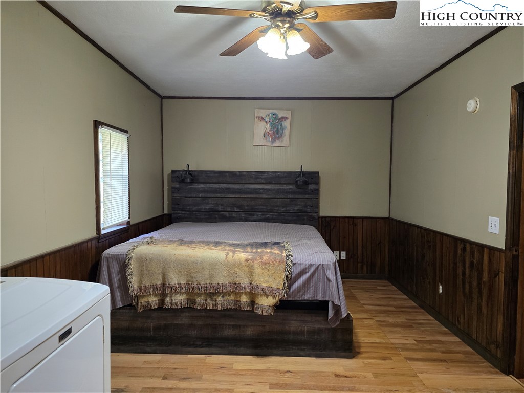 3160 Roundabout Road Creston, NC 28615 - Photo 24 of 50 a bed sitting in a bedroom and wooden floor