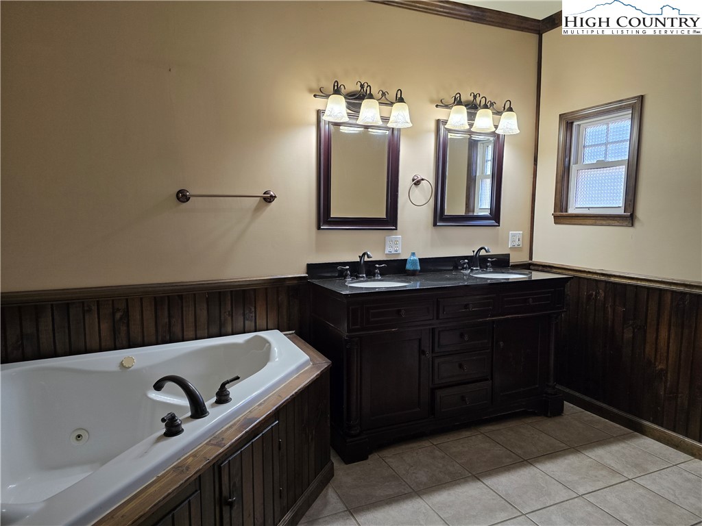 3160 Roundabout Road Creston, NC 28615 - Photo 27 of 50 a bathroom with a sink vanity and mirror