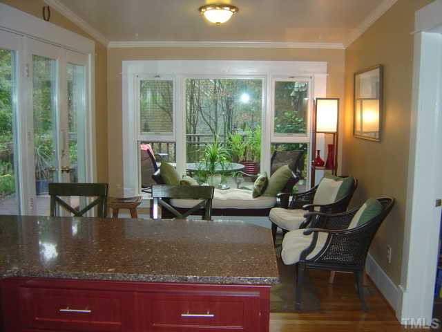 911 Brooks Avenue Raleigh, NC 27607 - Photo 6 of 12 This is the view from the newly-renovated kitchen toward the rear of the home and the sunroom. Left side of the house and kitchen faces South and gathers sunlight all day long. Kitchen