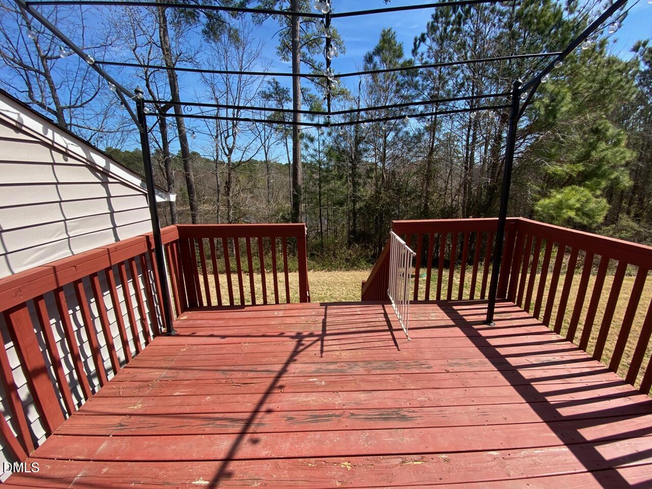 2513 Bay Harbor Drive Raleigh, NC 27604 - Photo 18 of 19 a balcony with wooden floor outdoor seating and yard in the back