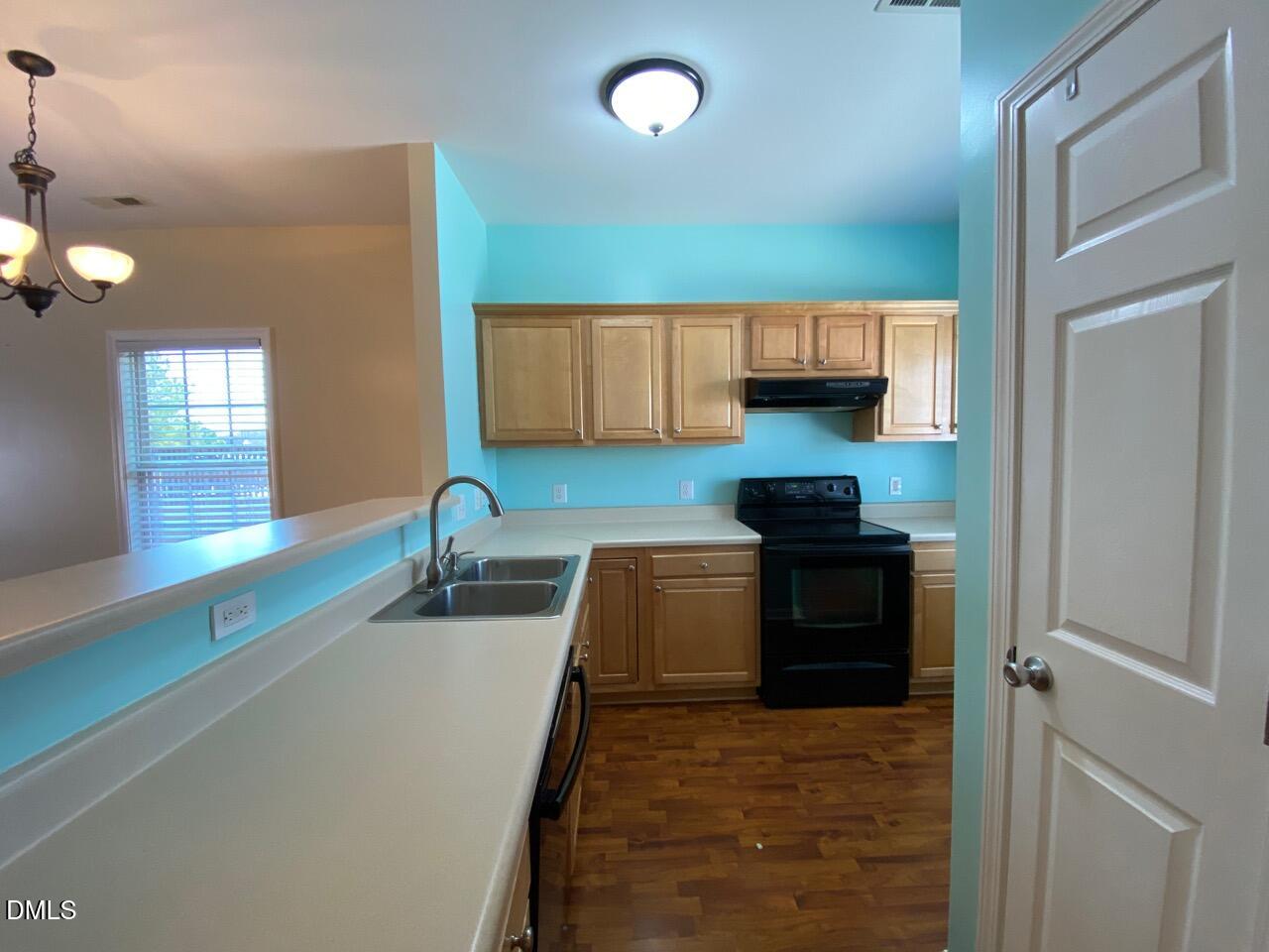 2513 Bay Harbor Drive Raleigh, NC 27604 - Photo 4 of 19 a kitchen with granite countertop a sink and a stove top oven