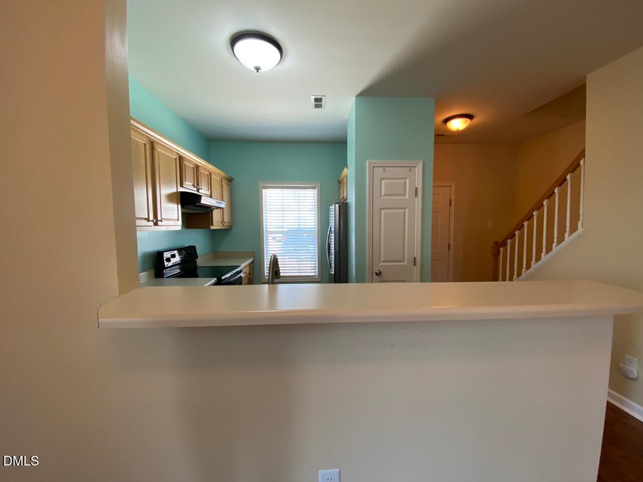 2513 Bay Harbor Drive Raleigh, NC 27604 - Photo 5 of 19 a view of a kitchen with a sink and a refrigerator