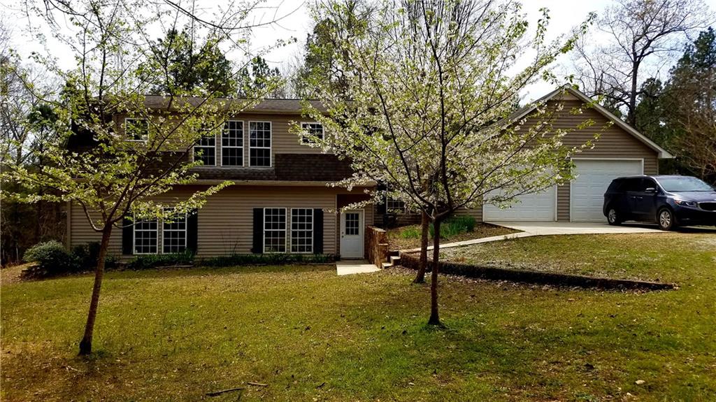 a front view of a house with a yard