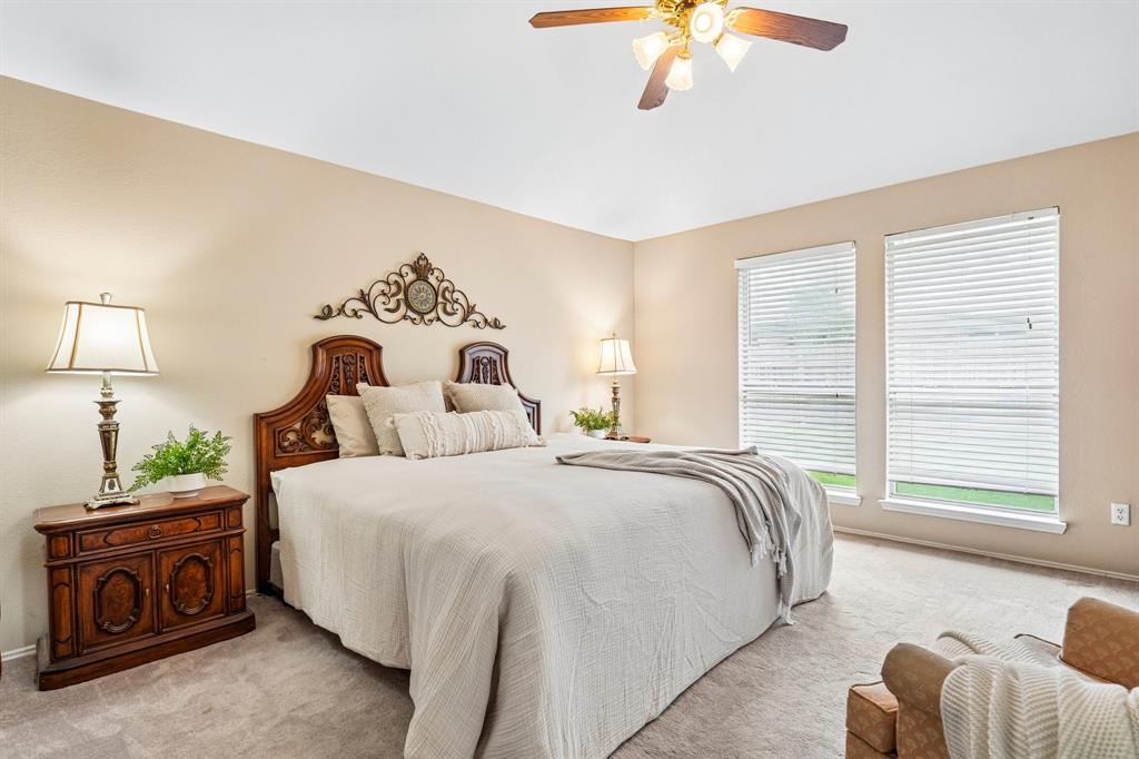 2705 Burning Tree McKinney, TX 75072 - Photo 19 of 35 a bedroom with bed and a chandelier