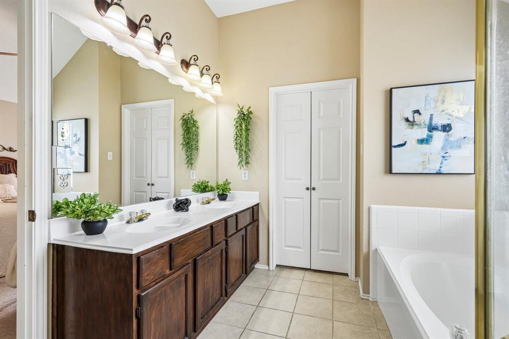 2705 Burning Tree McKinney, TX 75072 - Photo 21 of 35 a bathroom with a double vanity sink mirror and bathtub