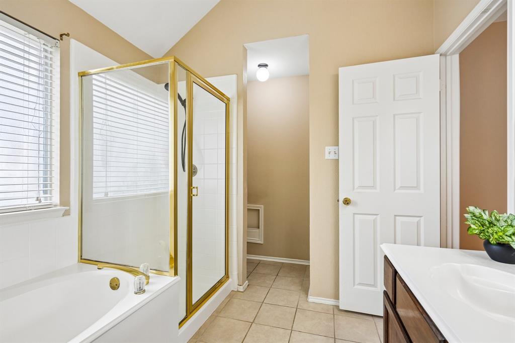 2705 Burning Tree McKinney, TX 75072 - Photo 22 of 35 a bathroom with a tub and shower