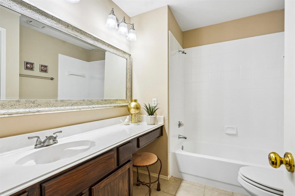 2705 Burning Tree McKinney, TX 75072 - Photo 29 of 35 a bathroom with a granite countertop sink mirror and a bathtub