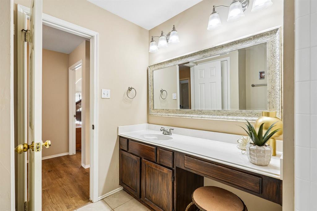 2705 Burning Tree McKinney, TX 75072 - Photo 30 of 35 a bathroom with a sink a mirror and a shower