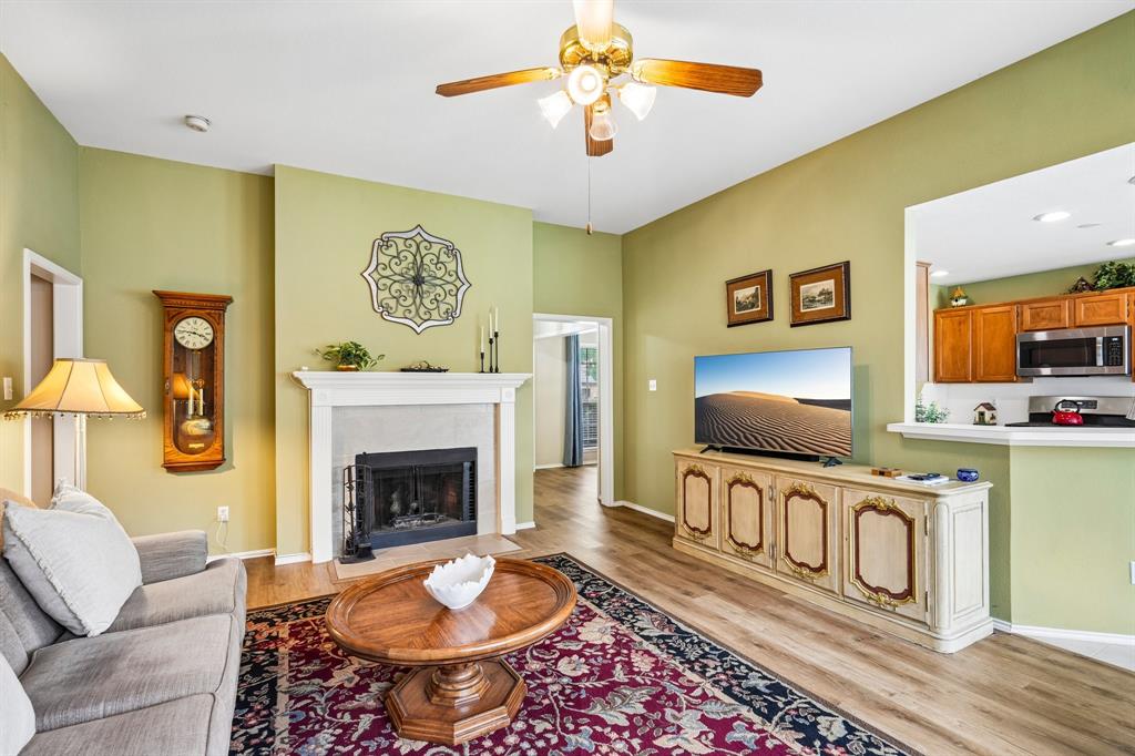 2705 Burning Tree McKinney, TX 75072 - Photo 7 of 35 a living room with furniture a flat screen tv and a fireplace