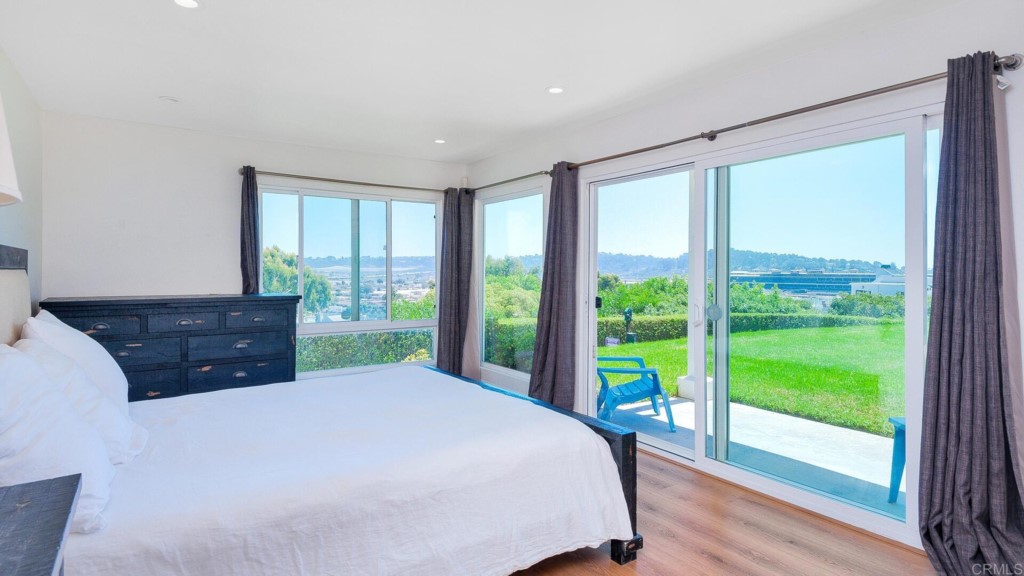 365 Longden Lane Solana Beach, CA 92075 - Photo 2 of 26 a bed sitting in a bedroom next to a large window with yard