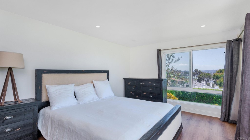 365 Longden Lane Solana Beach, CA 92075 - Photo 4 of 26 a large bed sitting in a bedroom next to a window