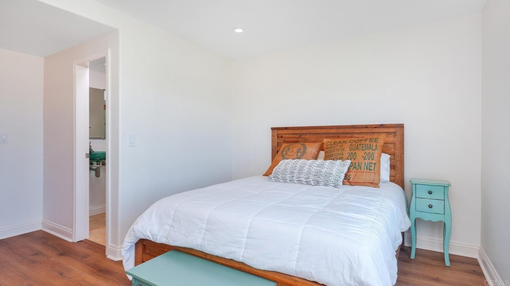 365 Longden Lane Solana Beach, CA 92075 - Photo 7 of 26 a bedroom with a bed and wooden floor