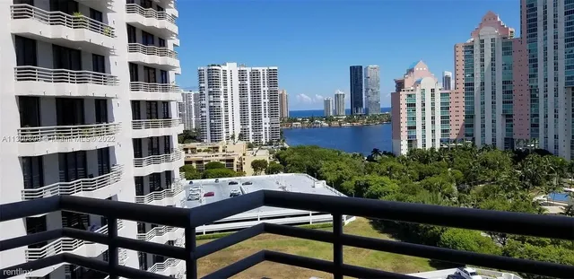a view of a balcony with furniture and a potted plant