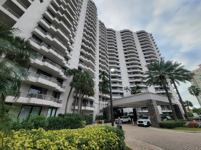 a front view of a multi story building with a yard