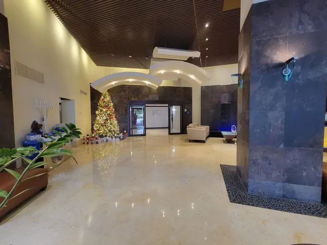 a lobby with furniture and a chandelier
