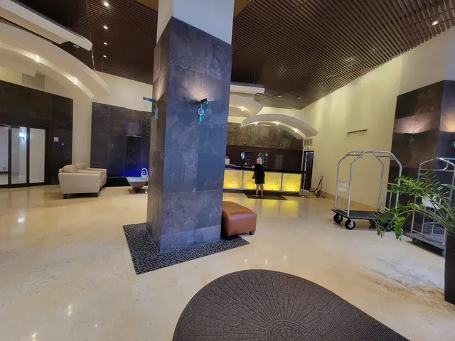 a lobby with furniture and mirror