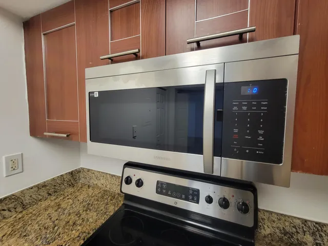a kitchen with a stove and a microwave